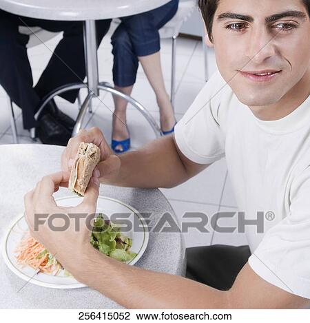 Man eating a sandwich View Large Photo Image Stock Image - Man eating a sandwich. Fotosearch