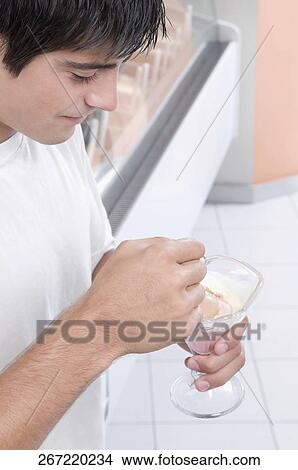 Man eating an ice cream View Large Photo Image Picture - Man eating an ice cream. Fotosearch