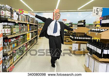 Man enjoying in a supermarket View Large Photo Image Stock Photo - Man enjoying in a supermarket. Fotosearch