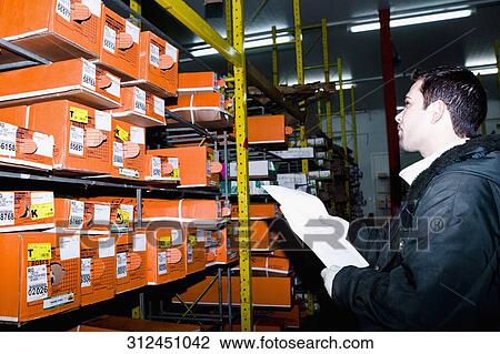 Man examining flower boxes in a warehouse, Miami, Florida, USA View Large Photo Image Stock Image - Man examining flower boxes in a warehouse, Miami, Florida, USA. Fotosearch