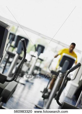 Stock Image - Man exercising in a gym. Fotosearch