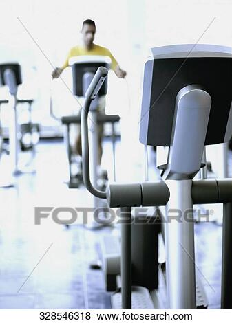 Man exercising in a gym View Large Photo Image Stock Photo - Man exercising in a gym. Fotosearch