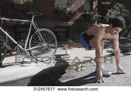Man exercising in a street View Large Photo Image Stock Photo - Man exercising in a street. Fotosearch