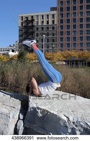 Man exercising on a stone View Large Photo Image Stock Image - Man exercising on a stone. Fotosearch