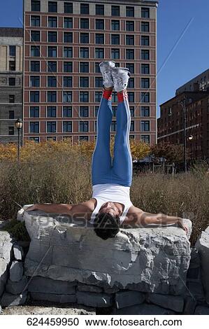 Man exercising on a stone View Large Photo Image Stock Image - Man exercising on a stone. Fotosearch