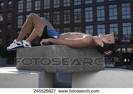 Man exercising on a stone View Large Photo Image Stock Photo - Man exercising on a stone. Fotosearch