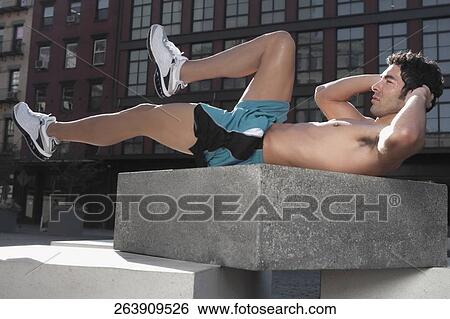 Man exercising on a stone View Large Photo Image Stock Photograph - Man exercising on a stone. Fotosearch