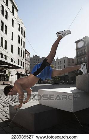 Stock Photo - Man exercising on stones. Fotosearch