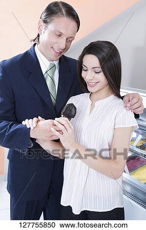 Man feeding ice cream to a woman View Large Photo Image Stock Image - Man feeding ice cream to a woman. Fotosearch