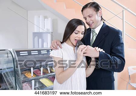 Man feeding ice cream to a woman View Large Photo Image Stock Photo - Man feeding ice cream to a woman. Fotosearch