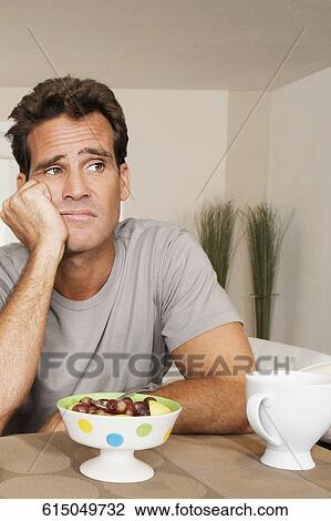 Man frowning at a bowl of fruits View Large Photo Image Stock Image - Man frowning at a bowl of fruits. Fotosearch