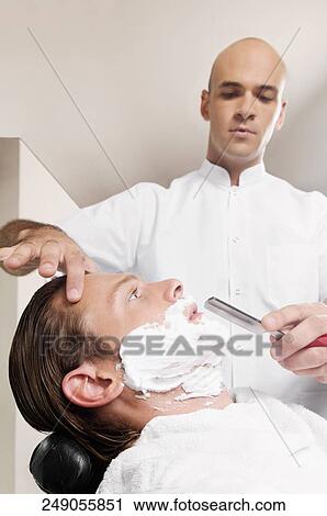 Man getting shaved in a salon View Large Photo Image Stock Image - Man getting shaved in a salon. Fotosearch