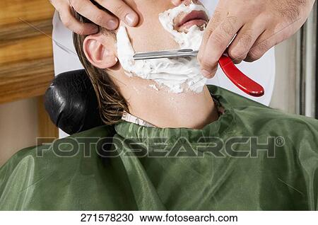 Man getting shaved in a salon View Large Photo Image Stock Image - Man getting shaved in a salon. Fotosearch
