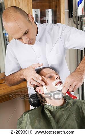 Man getting shaved in a salon View Large Photo Image Stock Image - Man getting shaved in a salon. Fotosearch