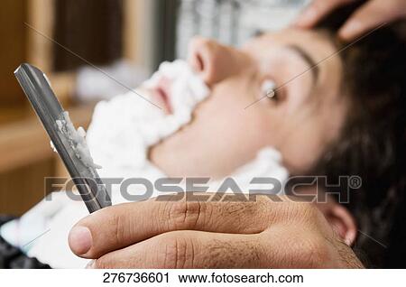 Man getting shaved in a salon View Large Photo Image Stock Image - Man getting shaved in a salon. Fotosearch