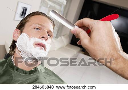 Man getting shaved in a salon View Large Photo Image Stock Image - Man getting shaved in a salon. Fotosearch