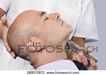 Man getting shaved in a salon View Large Photo Image Stock Image - Man getting shaved in a salon. Fotosearch