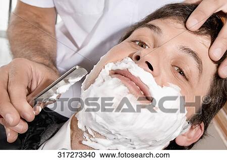 Man getting shaved in a salon View Large Photo Image Stock Image - Man getting shaved in a salon. Fotosearch