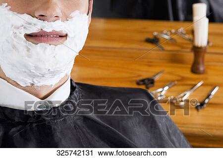 Man getting shaved in a salon View Large Photo Image Stock Image - Man getting shaved in a salon. Fotosearch