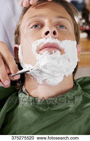 Man getting shaved in a salon View Large Photo Image Stock Image - Man getting shaved in a salon. Fotosearch
