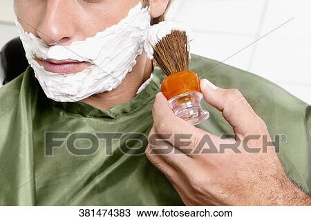 Man getting shaved in a salon View Large Photo Image Stock Image - Man getting shaved in a salon. Fotosearch