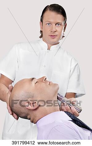 Man getting shaved in a salon View Large Photo Image Stock Image - Man getting shaved in a salon. Fotosearch