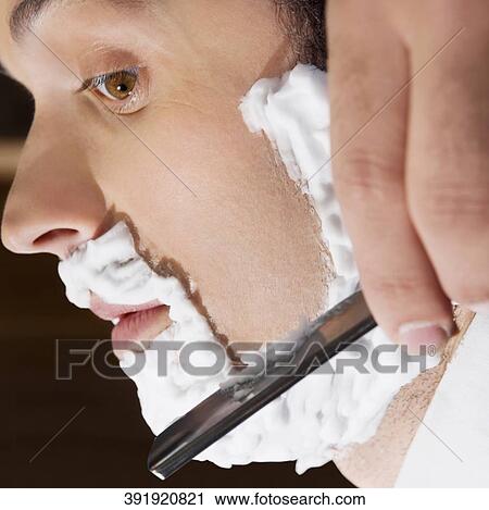 Man getting shaved in a salon View Large Photo Image Stock Image - Man getting shaved in a salon. Fotosearch