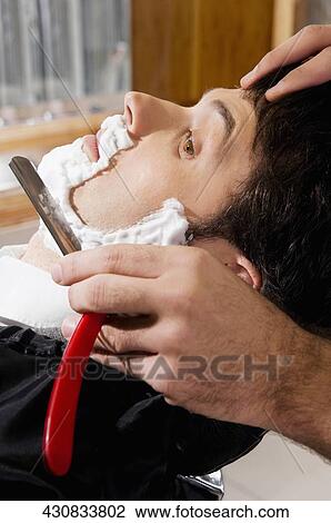 Man getting shaved in a salon View Large Photo Image Stock Image - Man getting shaved in a salon. Fotosearch