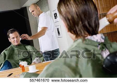 Stock Image - Man getting shaved in a salon. Fotosearch
