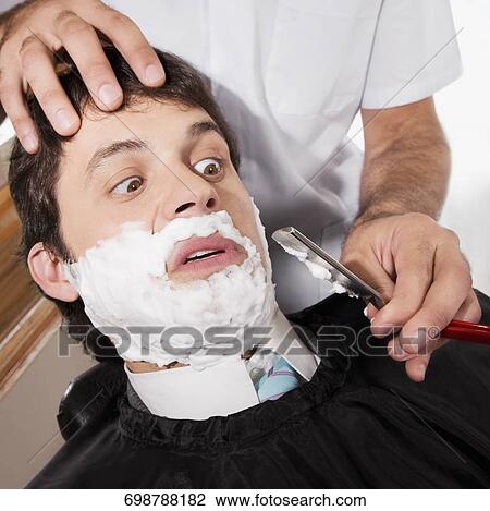 Man getting shaved in a salon View Large Photo Image Stock Image - Man getting shaved in a salon. Fotosearch