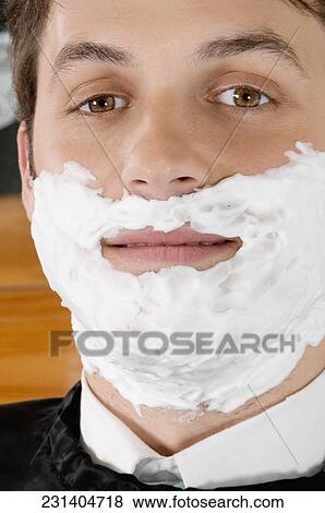 Man getting shaved in a salon View Large Photo Image Stock Photo - Man getting shaved in a salon. Fotosearch
