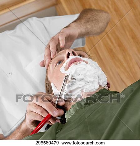 Man getting shaved in a salon View Large Photo Image Stock Photo - Man getting shaved in a salon. Fotosearch