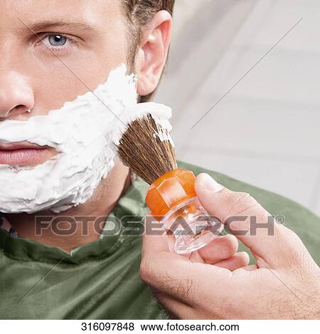 Man getting shaved in a salon View Large Photo Image Stock Photo - Man getting shaved in a salon. Fotosearch