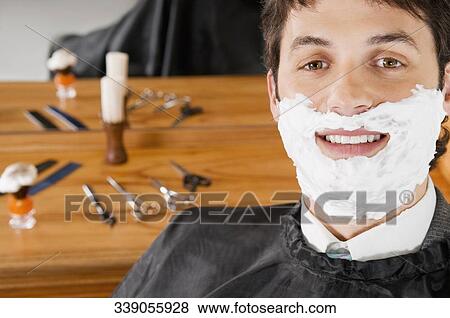Man getting shaved in a salon View Large Photo Image Stock Photo - Man getting shaved in a salon. Fotosearch