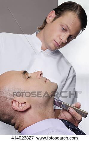 Man getting shaved in a salon View Large Photo Image Stock Photo - Man getting shaved in a salon. Fotosearch