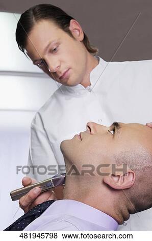 Man getting shaved in a salon View Large Photo Image Stock Photo - Man getting shaved in a salon. Fotosearch
