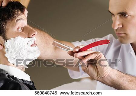 Man getting shaved in a salon View Large Photo Image Stock Photography - Man getting shaved in a salon. Fotosearch