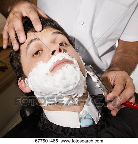 Man getting shaved in a salon View Large Photo Image Stock Photography - Man getting shaved in a salon. Fotosearch