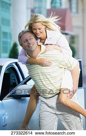 Man giving piggyback ride to his wife and smiling, Biltmore Hotel, Coral Gables, Florida, USA View Large Photo Image Picture - Man giving piggyback ride to his wife and smiling, Biltmore Hotel, Coral Gables, Florida, USA. Fotosearch