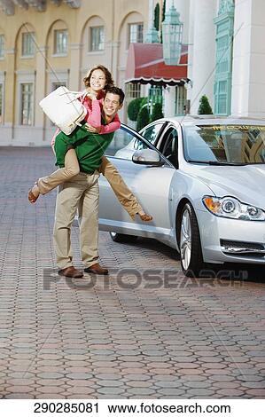 Man giving piggyback ride to his wife and smiling, Biltmore Hotel, Coral Gables, Florida, USA View Large Photo Image Stock Image - Man giving piggyback ride to his wife and smiling, Biltmore Hotel, Coral Gables, Florida, USA. Fotosearch