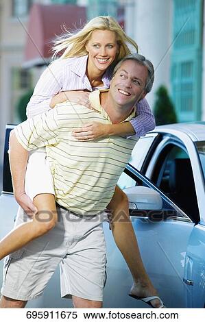 Man giving piggyback ride to his wife and smiling, Biltmore Hotel, Coral Gables, Florida, USA View Large Photo Image Stock Photography - Man giving piggyback ride to his wife and smiling, Biltmore Hotel, Coral Gables, Florida, USA. Fotosearch