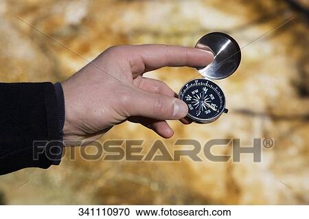 Man holding a compass, Mammoth Hot Springs, Yellowstone National Park, Wyoming, USA View Large Photo Image Stock Image - Man holding a compass, Mammoth Hot Springs, Yellowstone National Park, Wyoming, USA. Fotosearch