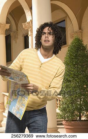 Man holding a map, Biltmore Hotel, Coral Gables, Florida, USA View Large Photo Image Stock Photo - Man holding a map, Biltmore Hotel, Coral Gables, Florida, USA. Fotosearch