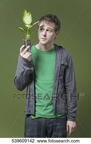 Stock Image - Man holding a seedling. Fotosearch