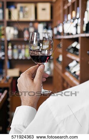 Man holding a wine glass View Large Photo Image Stock Image - Man holding a wine glass. Fotosearch