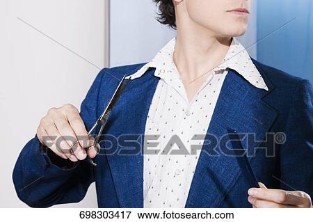Man holding scissors and a comb View Large Photo Image Stock Photo - Man holding scissors and a comb. Fotosearch