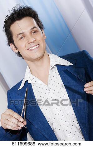 Stock Photography - Man holding scissors and a comb. Fotosearch