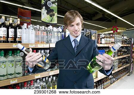 Man holding wine bottles View Large Photo Image Stock Photo - Man holding wine bottles. Fotosearch
