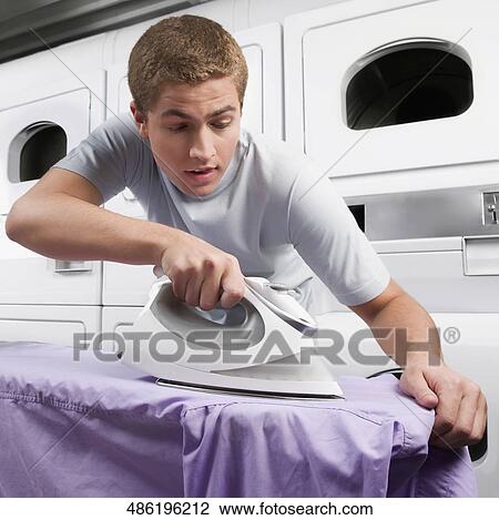 Man ironing a shirt View Large Photo Image Stock Image - Man ironing a shirt. Fotosearch