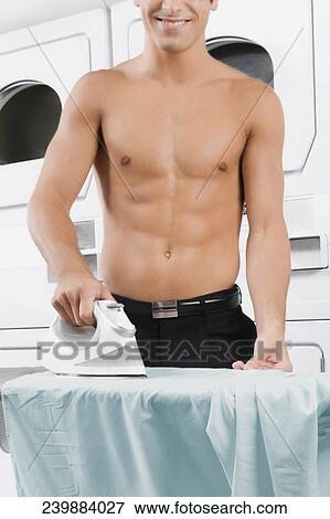 Stock Photo - Man ironing a shirt. Fotosearch